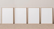 © lilasgh - Blank vertical poster frame mock up standing on beige floor. Four wooden frames isolated in Scandinavian interior. 3d render
