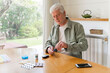 © Westend61 - Retired diabetic senior man using glaucometer during blood sugar test while sitting at table