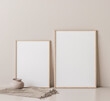 © lilasgh - Frame mock up in empty room on beige wall, two wooden frames standing on white floor, 3D render