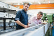© Westend61 - Two men examining piece of metal in a factory