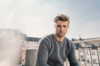 © Westend61 - Portrait of cool young man sitting on balcony