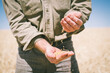 © Angie Roe/Austockphoto - A farmer handling wheat grain at harvest in the Wheatbelt of Western Australia