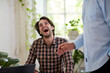 © Bec Hannaford/Austockphoto - Businessman laughing in an open space office