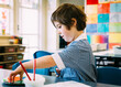 © Billie Leatham/Austockphoto - Little girl cutting & pasting in the classroom