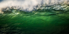 Wave Breaking In Big Surf, Green Water Backlit By Sunrise