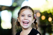 © Clare Farrelly/Austockphoto - Portrait of happy little six year old girl laughing with bokeh background