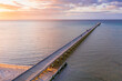 © Gary Chapman/Austockphoto - An aerial view of a long narrow jetty jutting out to sea at sunset