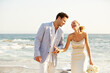 © Trinette Reed/Stocksy - Newlywed couple on the beach in Mexico