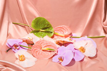 Anthuriums, Orchids And Florals On A Bed Of Pink Silk