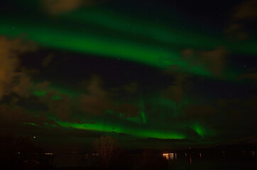 strong vibrant aurora borealis, northern light in autumn night in the arctic circle