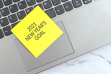 Wall Mural - New Year's Goal 2021 text on sticky note on top laptop