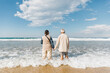 © Shikhar Bhattarai/Stocksy - Elderly senior South Asian couple on a beach.