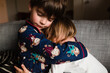 © Maria Manco/Stocksy - brother and sister hug