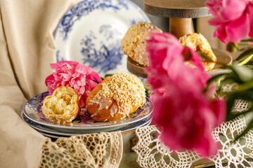 Wall Mural - Breakfast with croissants, leaves, flowers composition with retro plates on wooden background