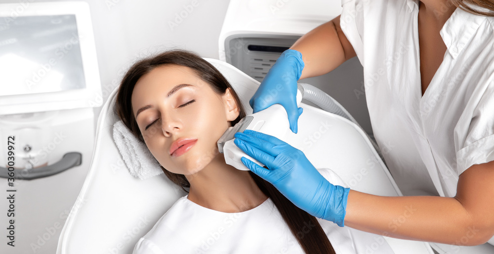 Elos epilation hair removal procedure on the face of a woman. Beautician doing laser rejuvenation in a beauty salon. Facial skin care. Hardware  ipl cosmetology - obrazy, fototapety, plakaty 