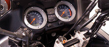 The Arrow Speedometer Of A Motorcycle On The Steering Wheel Closeup. Colored Dashboard With Sport Bike Handles, Top View. Horizontal Image Of A Tachometer Gauge. Banner For Web Site