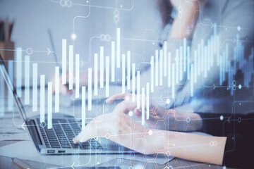 Multi exposure of woman hands typing on computer and financial chart hologram drawing. Stock market analysis concept.