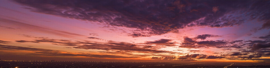 Wall Mural - Background of colorful sky concept: Dramatic sunset with twilight color sky and clouds.