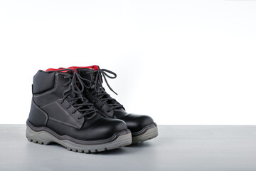 Protective boots on grey surface. Copy space.