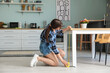 © Pixel-Shot - Young woman measuring table in kitchen