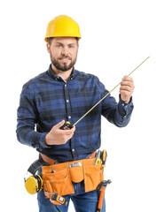 Wall Mural - Male worker with tape measure on white background