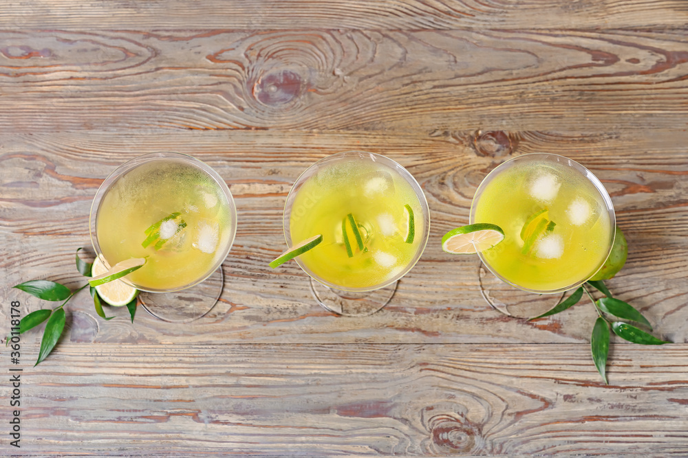 Glasses of tasty martini cocktail on table