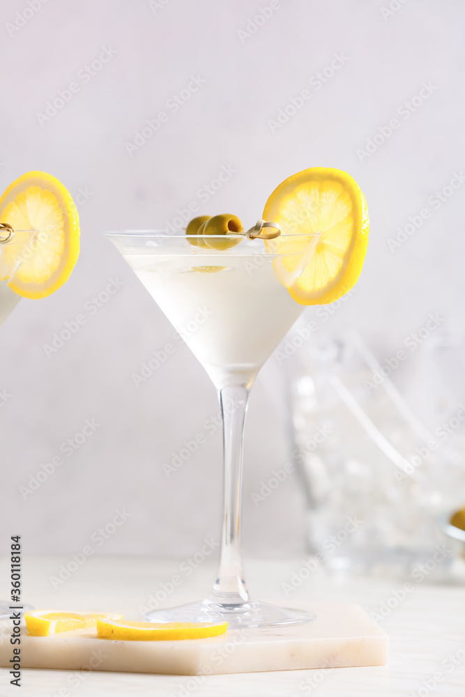 Glass of tasty martini cocktail on table