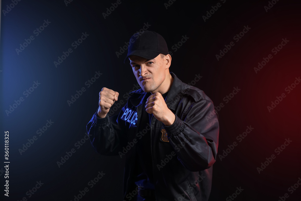 Aggressive police officer on dark background