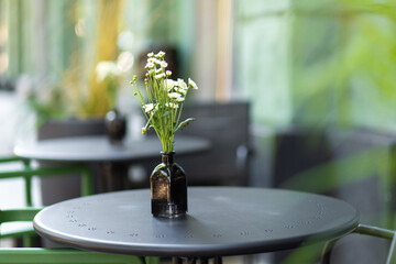 Wall Mural - Interior of a summer playground without people with fresh flowers in pots. A cozy cafe.