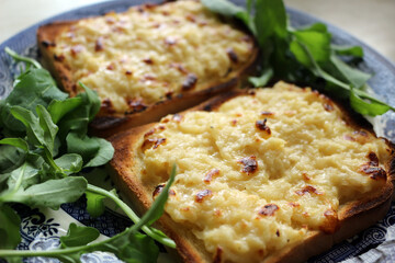 Wall Mural - Two pieces of cheese on toast served on a plate with salad