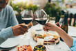 Romantic dinner outdoors, Young couple making cheers with wine glasses having date celebrating anniversary on terrace, Food Drink and Love concept, Couple in love Spending time together romantic date