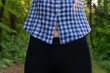 © yaroslav1986 - navel of a young slender woman after a workout is visible through the shirt