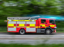 UK Fire Engine Responding To Emergency On Blue Lights