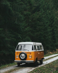 Vintage camper van on forest road. Transportation travel.