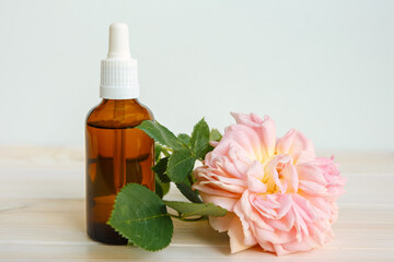 Rose and bottle with aromatic oil or medicine