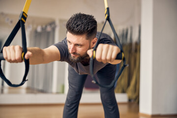 Wall Mural - Professional young sportsman stretching his lower back