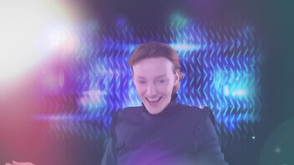 Poster - Animation of happy Caucasian woman laughing and dancing with colorful lights on background