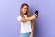 Young Brazilian woman isolated on purple background making a selfie
