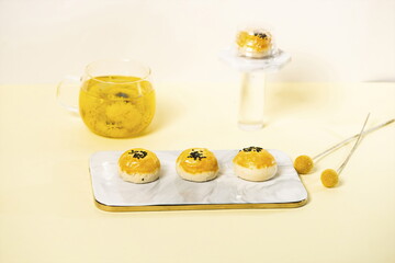 Wall Mural - Homemade egg-yolk puff for dessert, with a cup of chamomile tea on the side