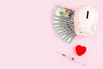 Wall Mural - piggy bank and red heart on pink background with copy space, flat lay, top view. Concept for money savings plan, or health care insurance. Mockup, template.