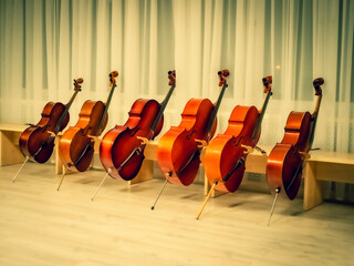 Many cellos in music in the concert hall before the concert.