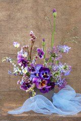 Beautiful elegant blue violet pink purple bouquet by florist with  pansy flowers. Floral background	