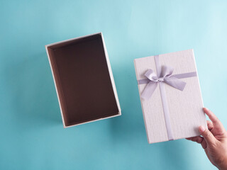 Canvas Print - Hands opening gift box, top view.