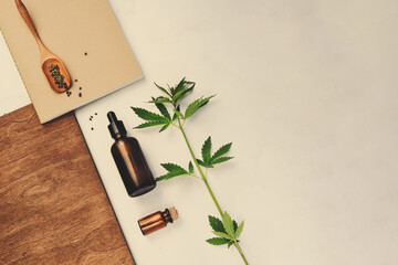 Wall Mural - CBD oil, tincture with a pipette on a beige background with hemp leaves. Concept medical cannabis Trendy Flat Lay Minimalism