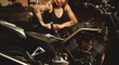 © Alex Tihonov - Blond woman mechanic repairing a motorcycle in a workshop