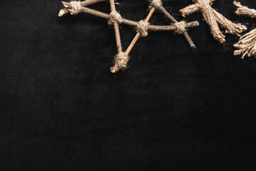 Poster - top view of voodoo doll near pentagram with wooden sticks on black