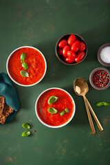 Poster - tomato and bell pepper vegetarian soup on green background