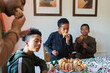 © Sam Edwards/Caia Image - Father and sons eating Christmas cake at table