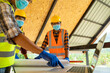 © visoot - Engineer wearing protective mask working and meeting at construction site.