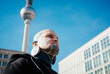 © fStop - Low angle view of man with tattoos and earplug earring standing outdoors